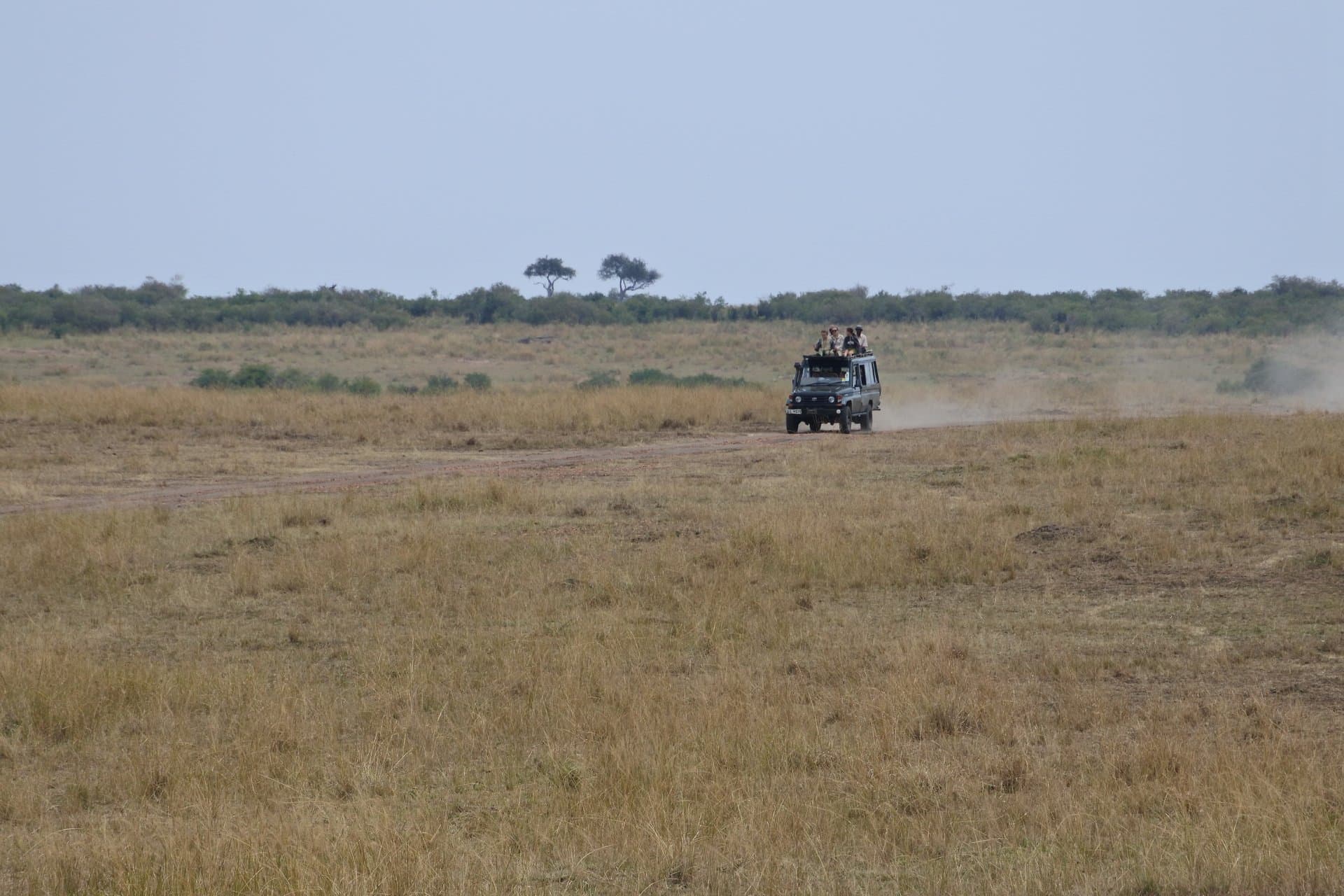 Safari game-viewer vehicle on a dirt track in Kenya