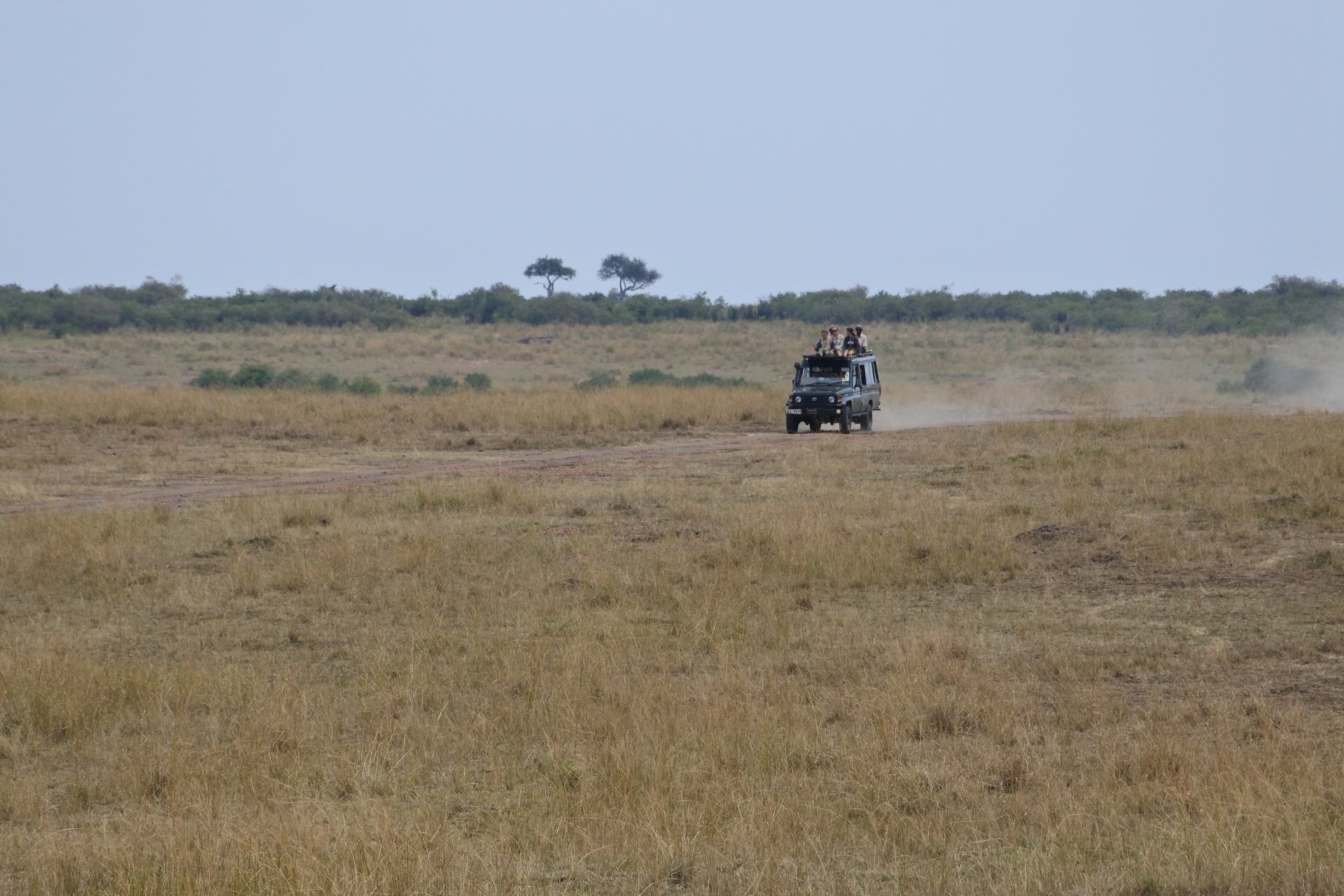 Safari game-viewer vehicle on a dirt track in Kenya